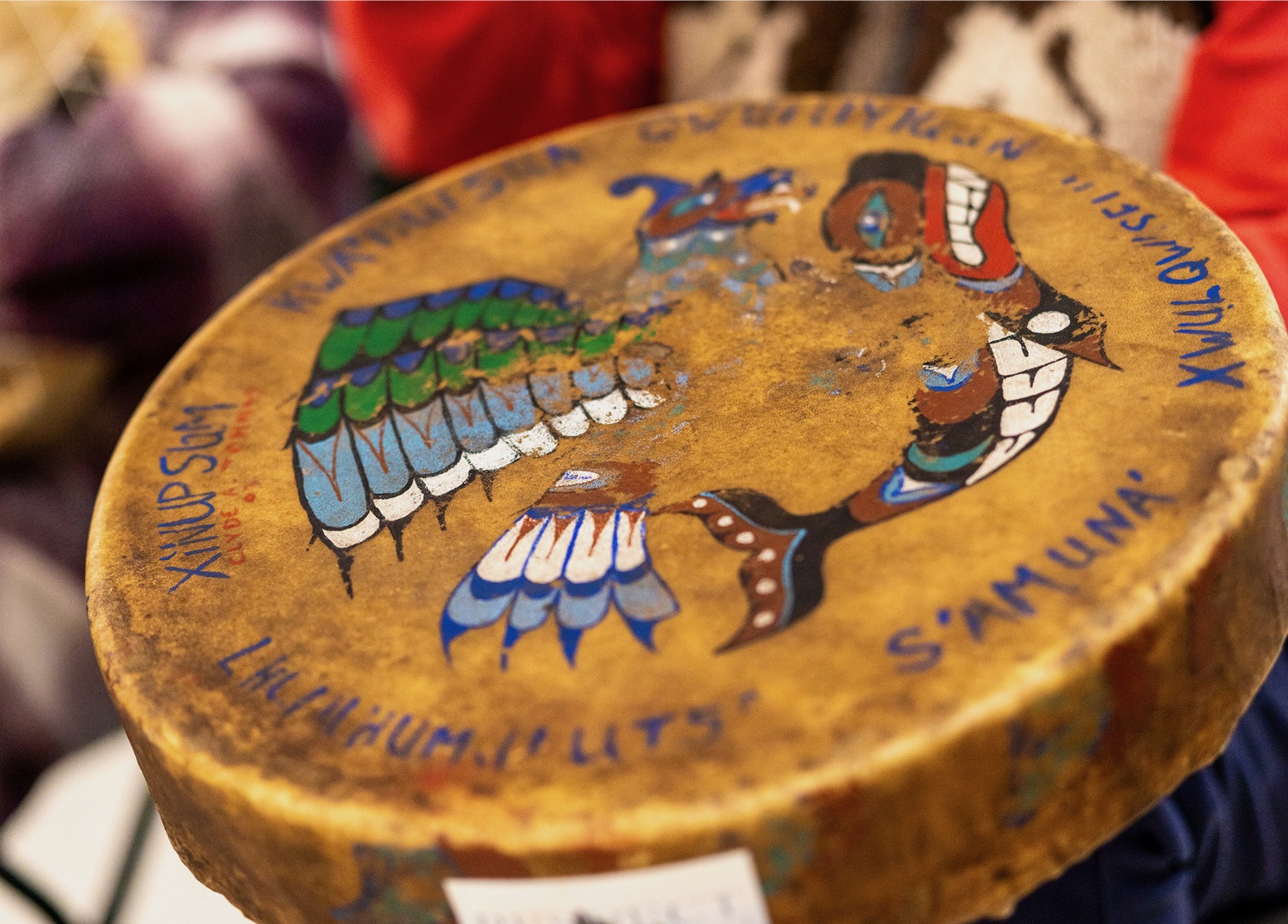 A blurry circular object with text and designs is present.